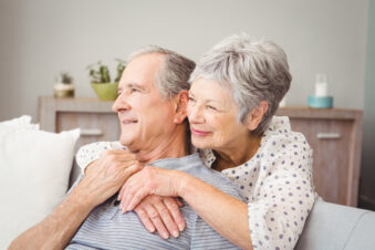 senior couple sitting in living room at home