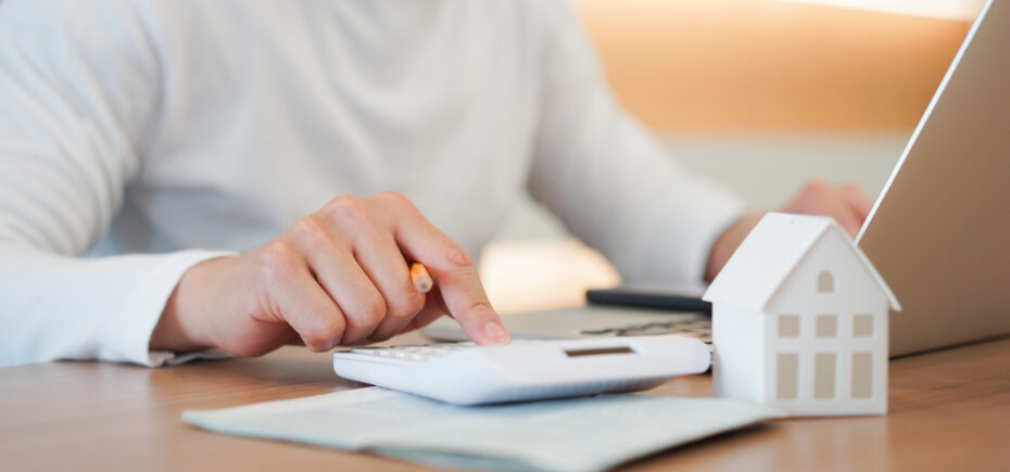 woman calculating Pros and Cons of Refinancing Mortgage